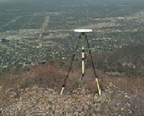 A survey tripod tool on top of a hillside